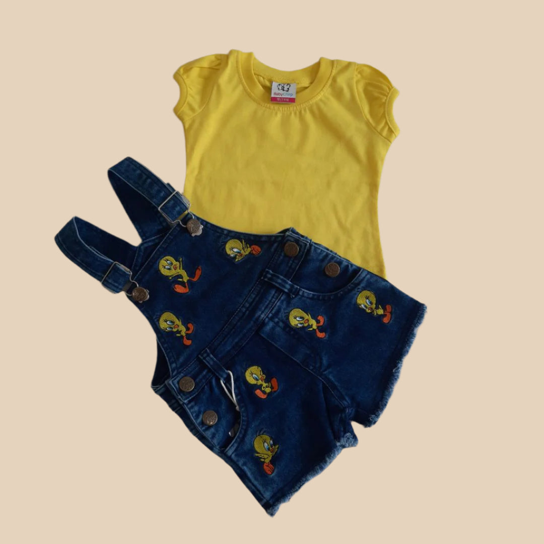 Yellow sleeveless shirt and blue denim overalls with cartoon character embroidery on a white background